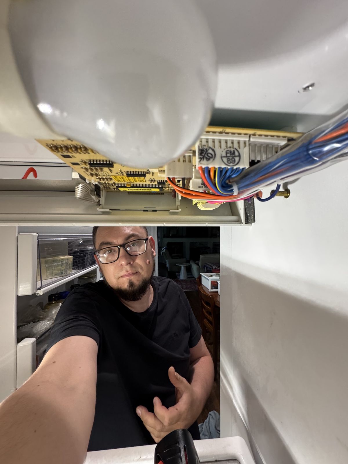 Zakhar working inside a refrigerator